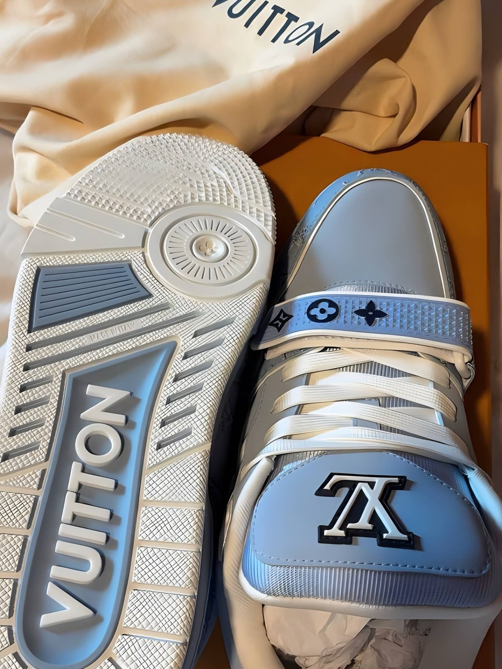 Louis Vuitton Men’s White and Light Blue LV Trainer Sneakers with Logo Strap